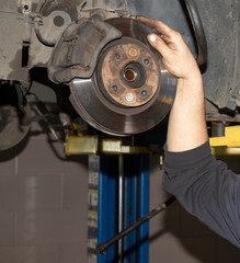 Car maintenance, hub and locksmith hand.