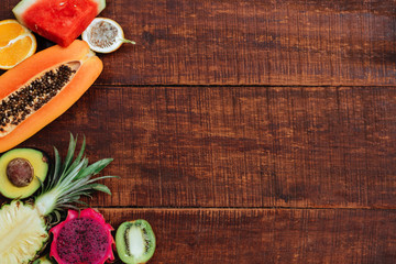 Tropical fruit on dark wooden background