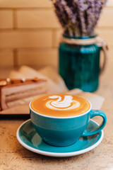 Coffee cappuccino and cake on the plate.