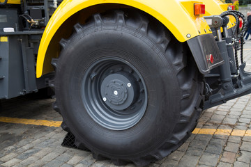 Fototapeta na wymiar Wheel large rubber agricultural tractor. Mechanical engineering, agriculture, useful machines.
