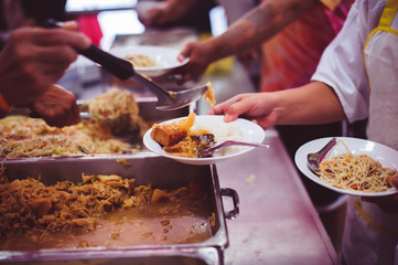 The Hands of the Poor Receive Charity Food Service from Volunteers :  The Concept of Poverty and Hungry