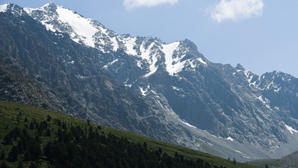 Rocky ridge under the snow. Mountain hiking, wilderness travel