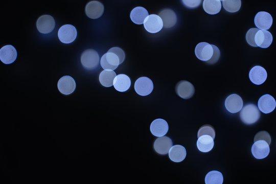 Defocused abstract blue christmas bokeh background copy space