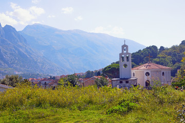 Sunny autumn, beautiful Mediterranean landscape. Montenegro, Prcanj town, view of Orthodox church of St. Peter of Cetinje ( Svetog Petra Cetinjskog )