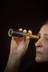 Woman looking through spyglass
