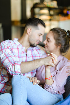 Young handsome boy hugging gilfriend wearing jeans.