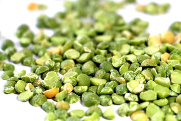  Dry green peas on a white background. Pea texture.  Chipped dry peas for soup.