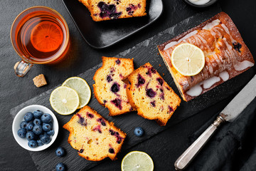 Homemade Blueberry Lemon Cake on black stone background.