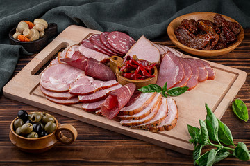smoked meat and sausages in assortment with herbs and spices