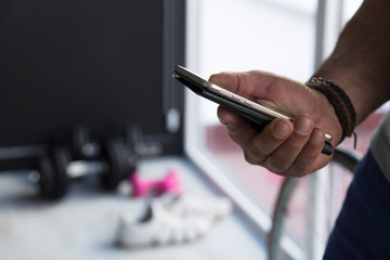 man using mobile phone in the gym