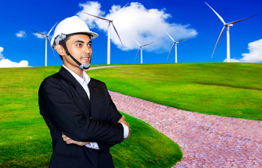 Windmill engineer or businessman standing on the wind turbine energy production and beautiful landscape