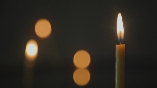 Wax candle and cross on a water surface in a Christian Chapel.