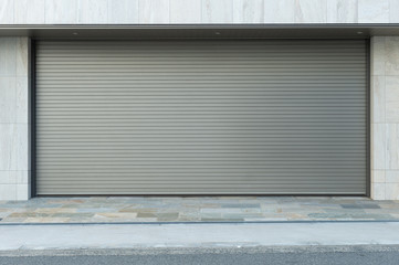 A closeup shot of automatic metal roller door used in factory, storage, garage, and industrial warehouse. The corrugated and foldable metal sheet offer space saving and provide urban and rustic feel