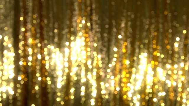 Golden seguin background with shiny reflection. Luxury disco or nightclub.