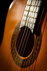 Obraz premium Strings on acoustic wooden guitar in morning sunlight