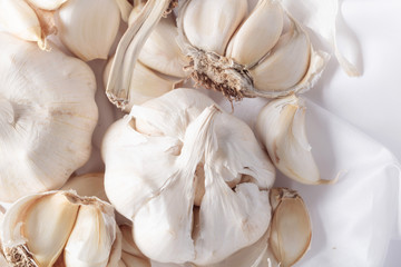 Fototapeta na wymiar Bulbs and garlic cloves on white textile.