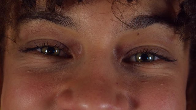 smiling eyes of making fun girl, front extreme close up shot