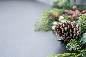 Christmas fir tree branches, winter background border over gray board, copy space. Winter greeting card, winter holidays.