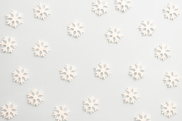 Winter background, white snowflakes over white board. Abstract Christmas winter texture.