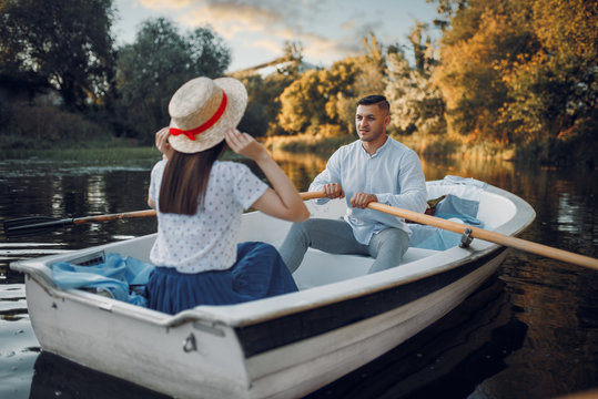 Love couple boating on lake at summer day