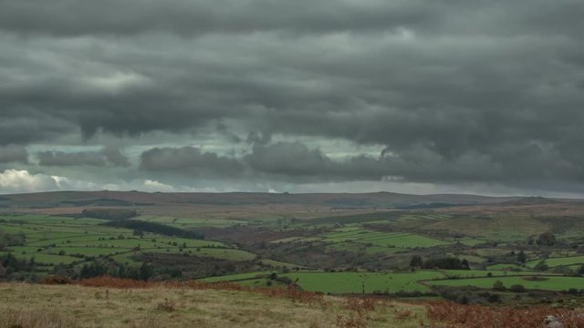 Time lapse of dark grey clouds over Dartmoor National Park & British countryside