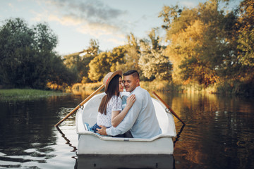 Happy love couple boating on lake, romantic date