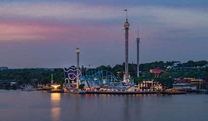 Fototapeta na wymiar Amusement park at sunset