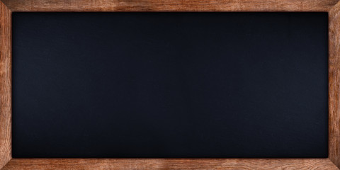 wide panorama dark stone slate blackboard or chalkboard with rustic wooden oak wood frame empty...