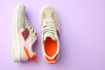 Pair of stylish shoes on lilac background, top view. Space for text