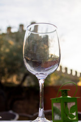 Empty wine glass with the background wall of Alcudia.