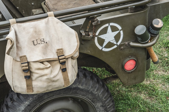 Close-up image of a US Army WW2 jeep showing captured German stick grenades together with a canvas ammo bag keep small calibre ammunition.