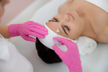 Pretty lady getting beauty injections at spa salon
