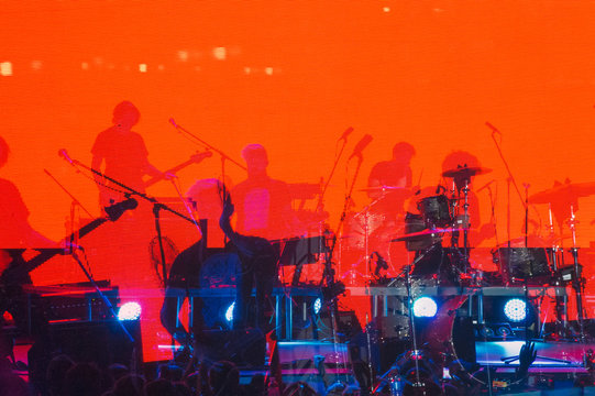 Blurred Background, Musical Rock Band Performs On Stage In The Light Of Spotlights, Rock Music Night Concert.