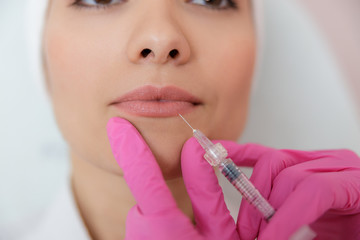 Young woman receiving beauty injection at spa salon