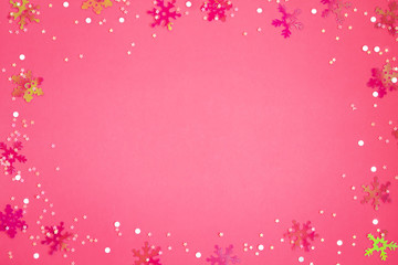 Christmas and new year background, blank of plastic snowflakes and stars on colored paper