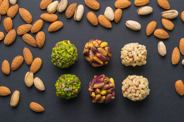 Middle east pistachio confectionery. Healthy no sugar food. Scattered pistachio and almond nuts. Top view.