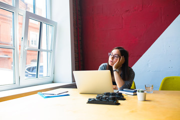 Tired lazy female bad business worker don't want work having work crisis while sitting at desktop with open laptop computer in office interior