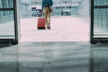 Man carrying suitcase in terminal stock photo