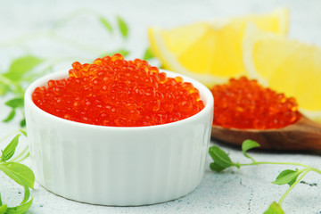 A small ceramic bowl with red caviar
