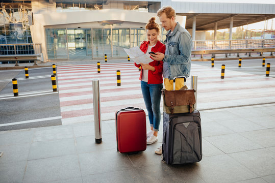 Jolly couple going on trip with luggage stock photo