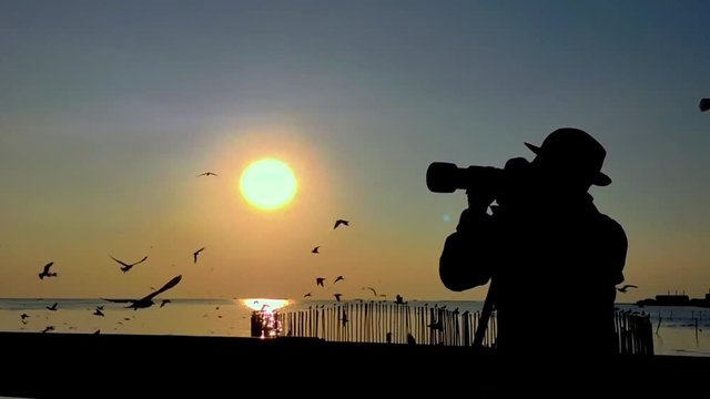 slow motion silhouette of photographer with camera