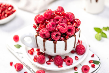 Raspberry mug cake in a white ceramic mug on white background