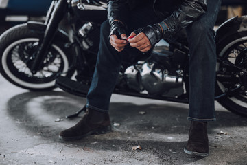 Obraz na płótnie Canvas Adult biker waiting for somebody on motorcycle