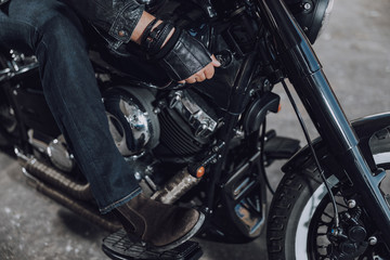 Obraz na płótnie Canvas Male biker sitting on modern black motorcycle
