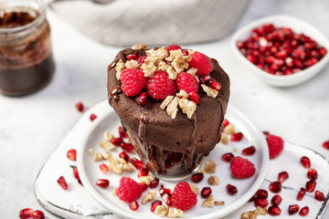 Raspberry mug cake in a glass on white background