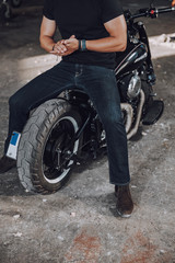 Obraz na płótnie Canvas Caucasian guy is sitting of his motorbike