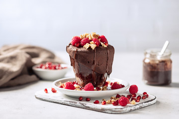 Raspberry mug cake in a glass on white background