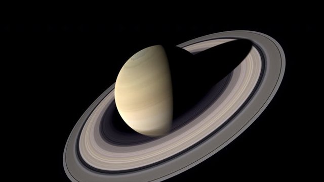 Saturn flyby traveling at one tenth the speed of light. Side view moving to top view of rings. Axis is accurately tilted by 26.73 degrees and shape bulges at equator forming oblate spheroid.