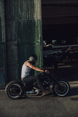 Fototapeta na wymiar Handsome man in helmet enjoying his trip by new motorbike