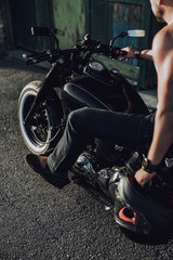 Obraz na płótnie Canvas Caucasian adult biker sitting on motorcycle on road